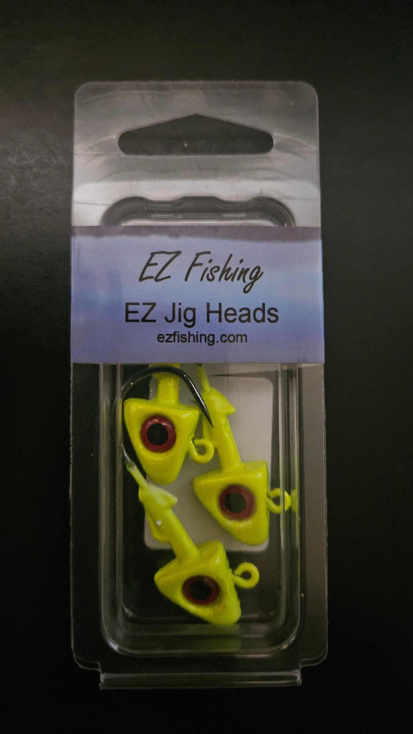 A picture showing a package of 3 EZ Jig Heads, ½ oz, Yellow with red eyes and 3/0 HooksA picture showing a packge of 3 EZ Jig Heads, ½ oz, Yellow with red eyes and 3/0 Hooks