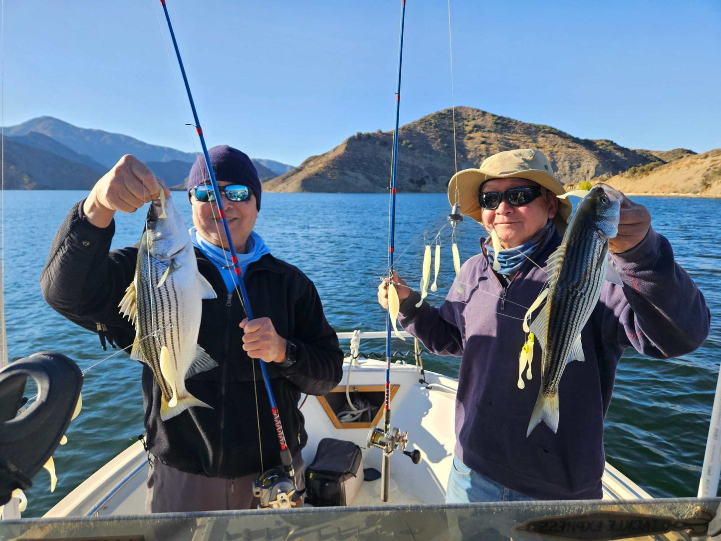 Guide Service, Two guys holding up their striper and 2 EZ U-Rigs