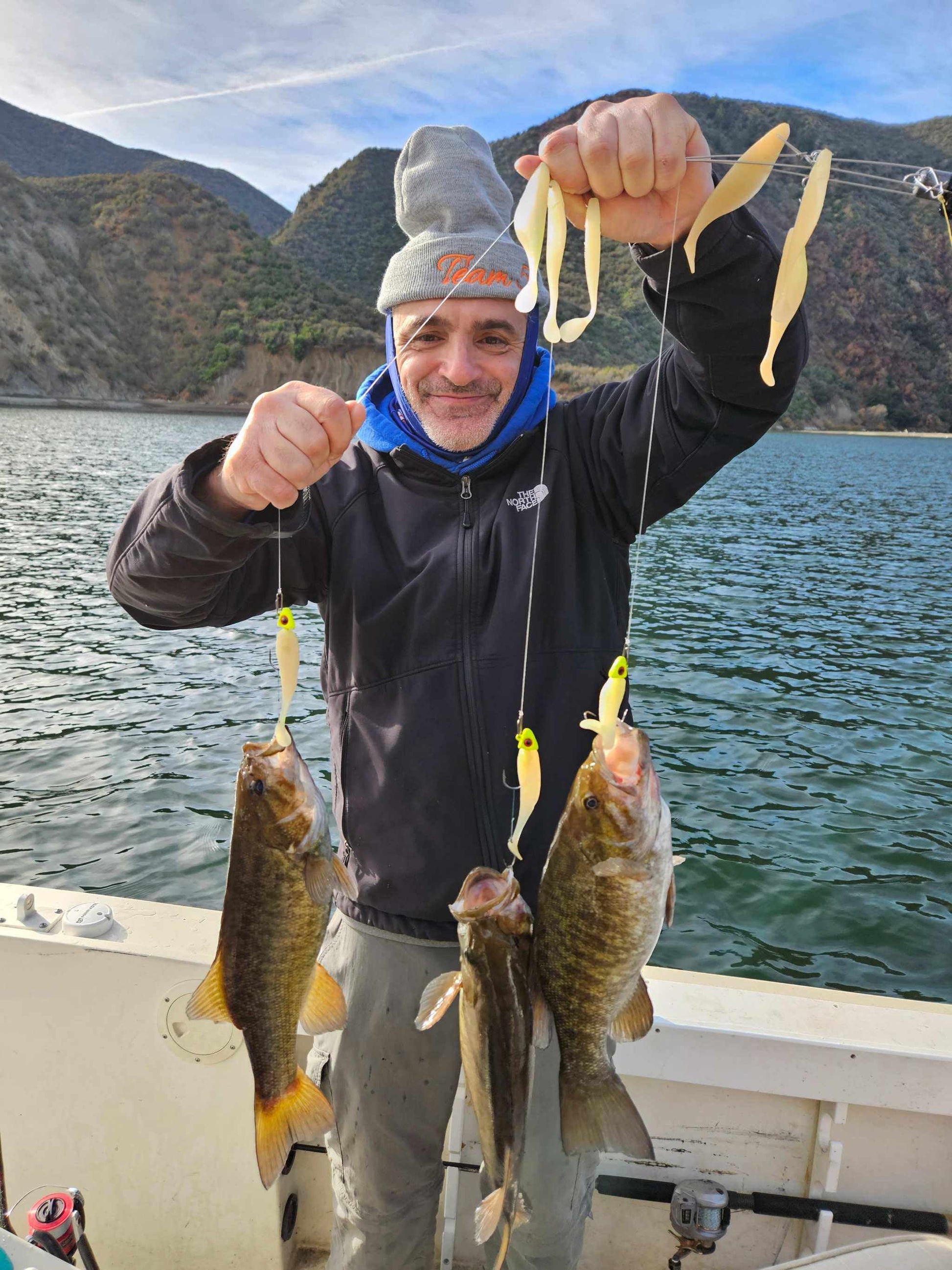 Guide Service, a man showing 3 smallmouthbass caught on an EZ U-Rig