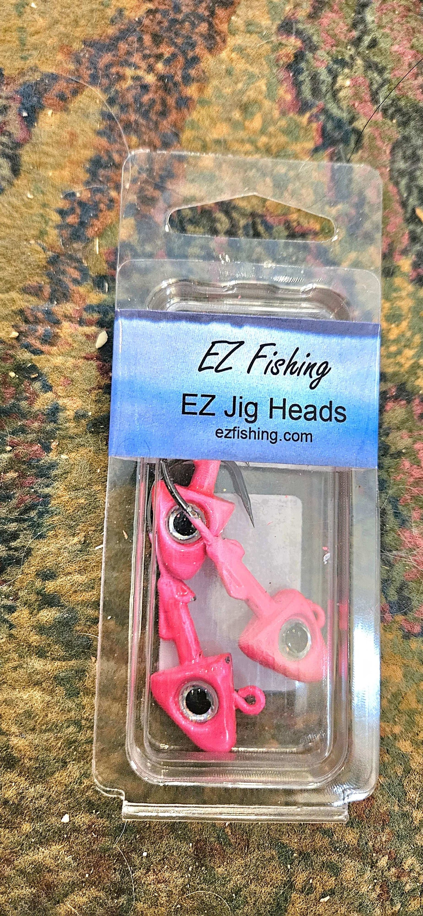 A picture showing a package of 3 EZ Jig Heads, ½ oz, Yellow with red eyes and 3/0 HooksA picture showing a packge of 3 EZ Jig Heads, ½ oz, pink with silver eyes and 3/0 Hooks